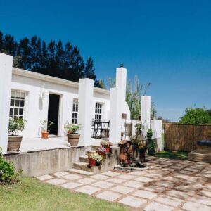 The Hamlet: a white house with a fence and a patio