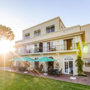 The Helderview Luxury Suites: a large white building with a lawn in front of it