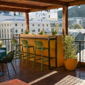 The Jester Boutique Hotel: a bar on a balcony with a view of a city