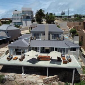 The Lookout Guest House: an aerial view of a house with chairs and umbrellas