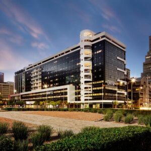 The Onyx Apartment Hotel by NEWMARK: a large building in a city at night