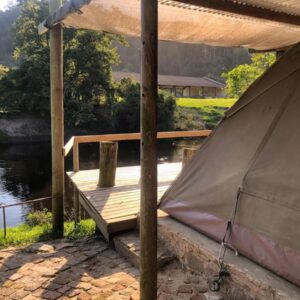 The Riverdeck Accommodation and Backpackers: a tent sitting on a dock next to a body of water