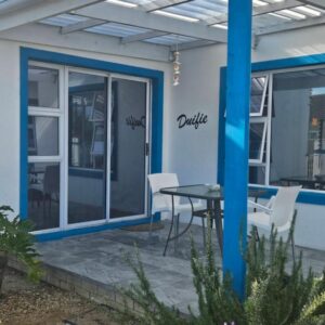 The Somerset nest: a patio with a table and chairs on it