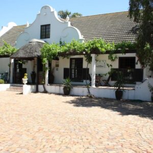 The Vinelands on Alpha Guest House: a white house with a cobblestone driveway