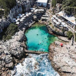The zen den shared dorm: an aerial view of a pool of water on a mountain