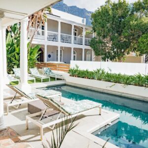Three Boutique Hotel: an exterior view of a house with a swimming pool