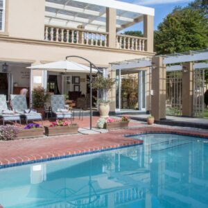 Tokai Forest Guest House: a swimming pool in front of a house