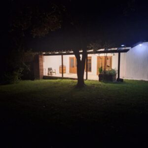 Tsitsikamma sunrise Guesthouse: a house at night with a tree in the yard