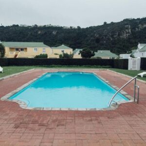 Twenty One River Club Villas: a large blue swimming pool on a brick patio