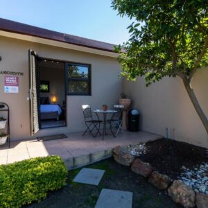 Tyger Classique Self-Catering Cape Town, Tyger Valley: a house with a patio with a table and a tree