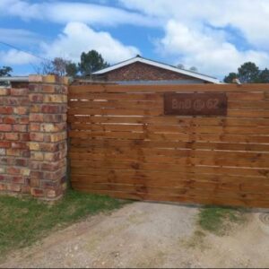 Venolla's: a wooden fence in front of a brick wall