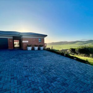 Verdant Hills: a brick house with a garage and a driveway