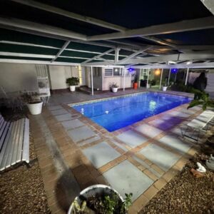 Vero Guest House On Pringle: a swimming pool in a building at night