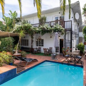 Villa Costa Rose - Adults Only: a swimming pool in front of a house