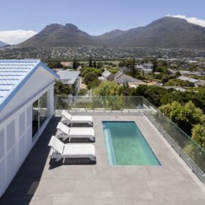 Villa Mykonos: a view of a house with a swimming pool and chairs