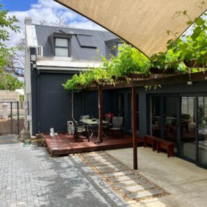 Vlettershof Guest House: a house with a patio with a table on it