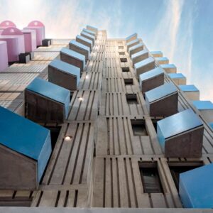 Vredenberg Building - Complex: a tall building with blue windows on the side of it