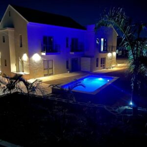 Vue de Valleé: a house with a swimming pool at night at Vue de Valle\u00e9 in Wellington