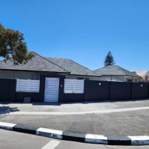Wagenaar Villas: a building with white doors and a fence