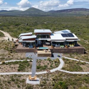 Walkerbay Dunes Lodge: an aerial view of a house in the middle of a field