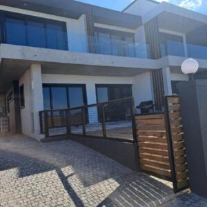 WavesEnd Wilderness Self-catering Units: a house with a fence in front of it