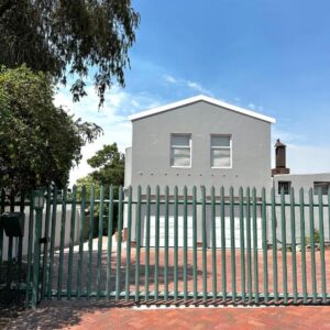 Wellway Place: a white house with a fence in front of it