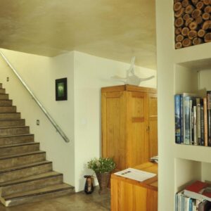 Whalesong Lodge: a staircase in a house with a book shelf