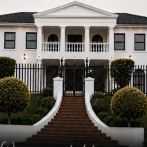 White House Manor: a white house with stairs in front of it