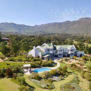 Wind-Rose Guest House: an aerial view of a large house with a swimming pool
