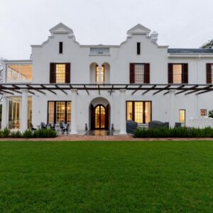 Wytham Manor House: a white house with a green lawn