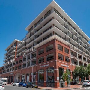 Xenia Aparthotel by Totalstay: a large red brick building on a city street