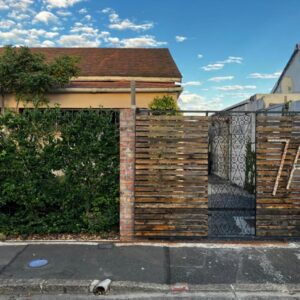 Your home in the Cape: a brick fence with a gate in front of a house