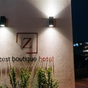 Zest Boutique Hotel by The Living Journey Collection: two lights on the side of a building with a hotel